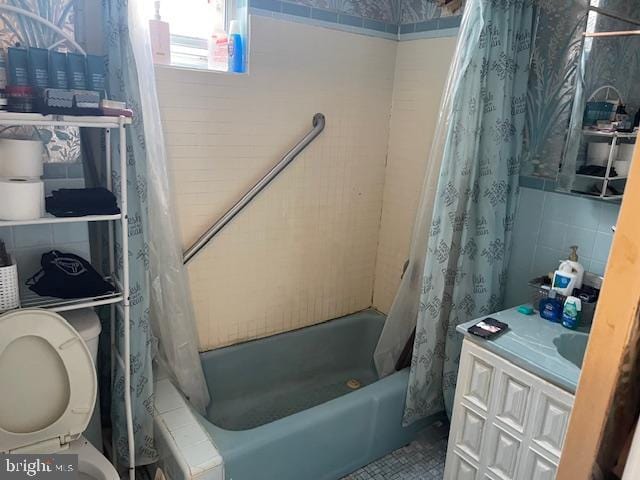 bathroom featuring shower / tub combo, tile walls, and toilet