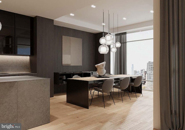 kitchen with decorative light fixtures, a notable chandelier, light hardwood / wood-style flooring, and a center island