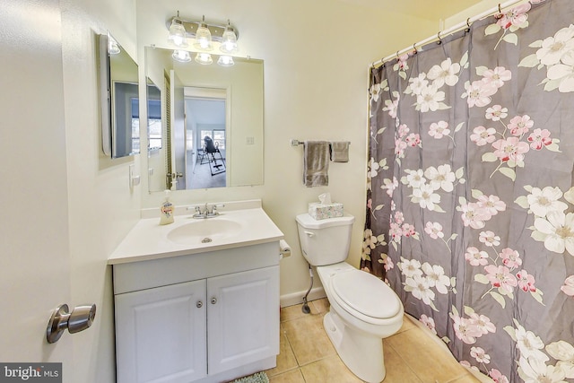 bathroom featuring vanity, tile patterned floors, and toilet