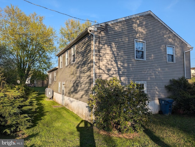 view of property exterior featuring a lawn