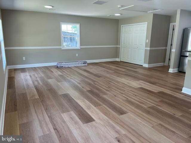 empty room with light hardwood / wood-style flooring