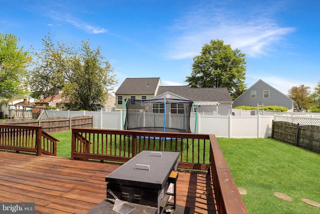 deck with a trampoline and a yard