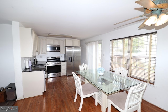 dining area with dark wood-type flooring, ceiling fan, and sink