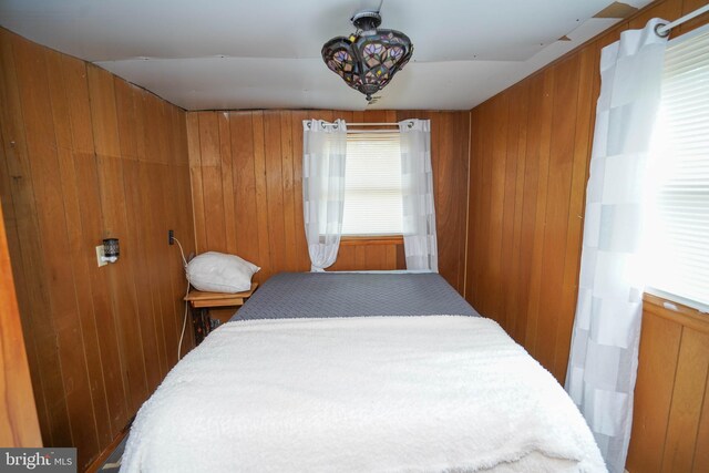 bedroom with wood walls