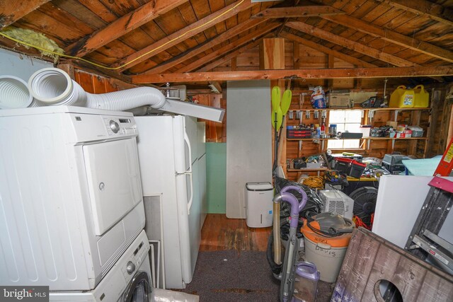 interior space with stacked washer / dryer, wooden ceiling, and hardwood / wood-style flooring