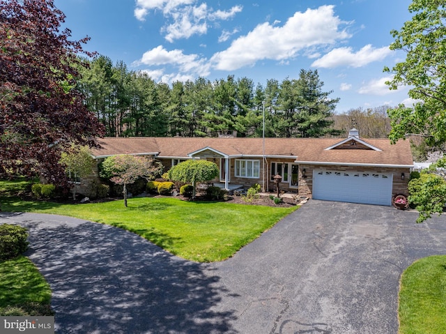 view of front of house with a garage and a front lawn