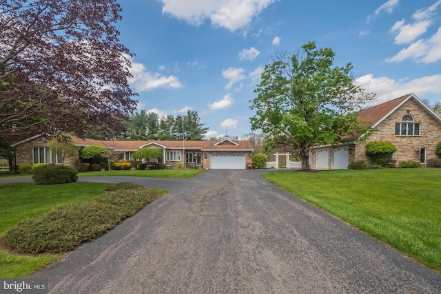 view of front of home featuring a garage and a front yard