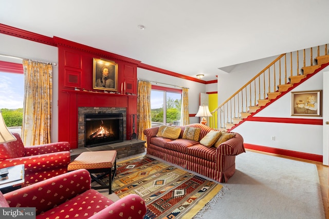 living room with ornamental molding and a fireplace