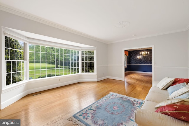 living room featuring ornamental molding, a healthy amount of sunlight, and hardwood / wood-style floors