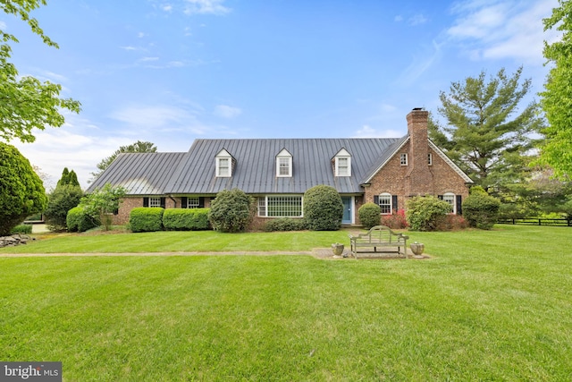 cape cod-style house with a front yard