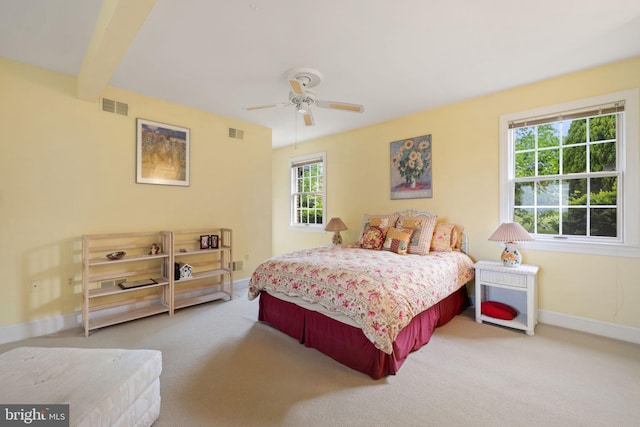 bedroom featuring carpet flooring, beam ceiling, and ceiling fan