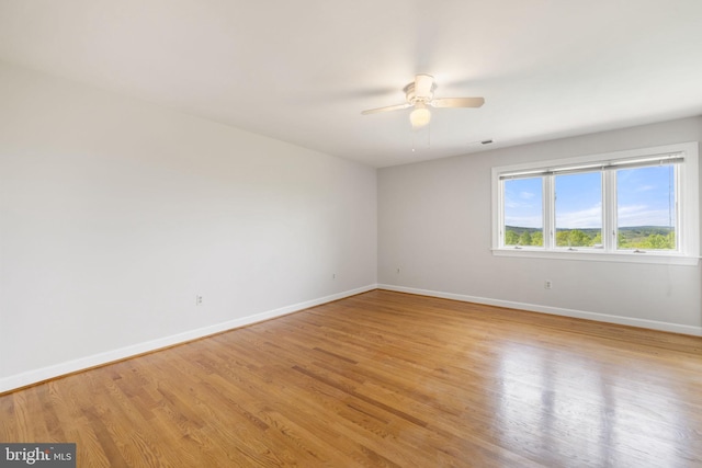 spare room featuring ceiling fan and hardwood / wood-style flooring