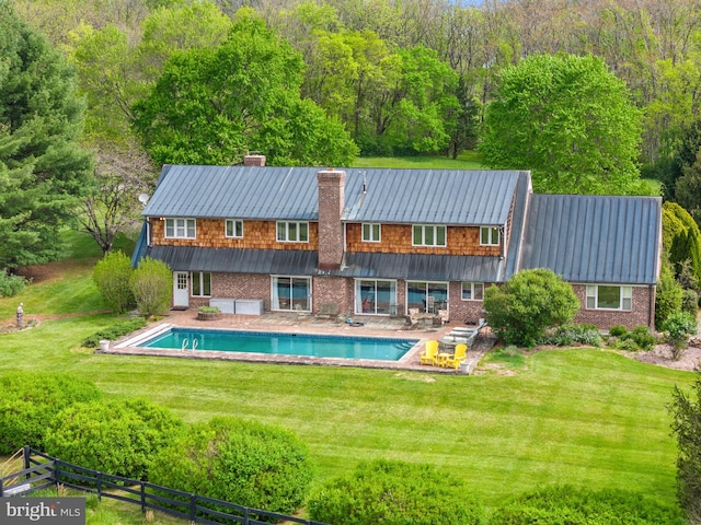 view of pool with a yard