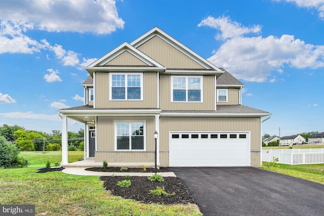 view of front of property with a garage and a front yard