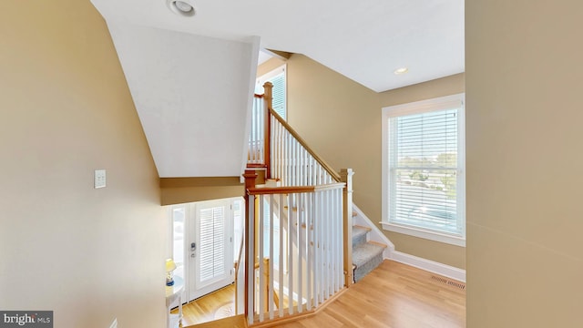 stairs featuring hardwood / wood-style flooring