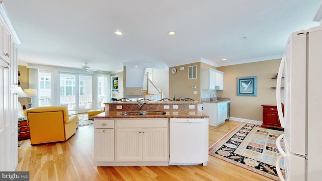 kitchen featuring white appliances, light hardwood / wood-style flooring, white cabinetry, and sink