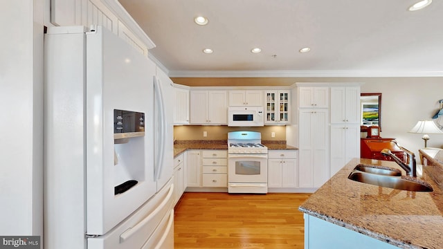 kitchen featuring white appliances, sink, ornamental molding, light hardwood / wood-style floors, and white cabinetry