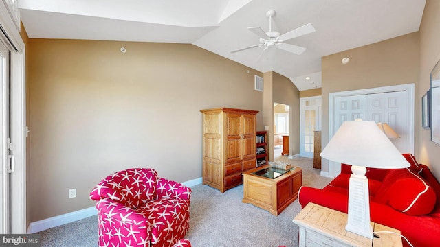 living room with carpet flooring, ceiling fan, and vaulted ceiling