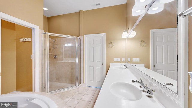 bathroom with tile patterned floors, vanity, and a shower with shower door