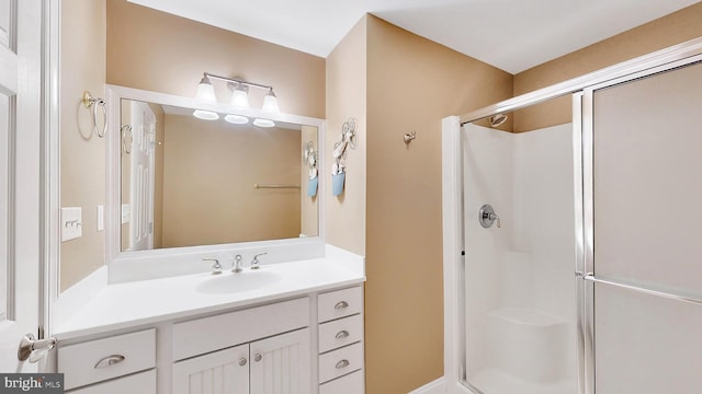 bathroom with vanity and a shower with shower door