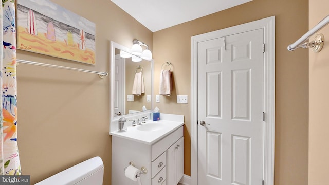 bathroom featuring vanity and toilet