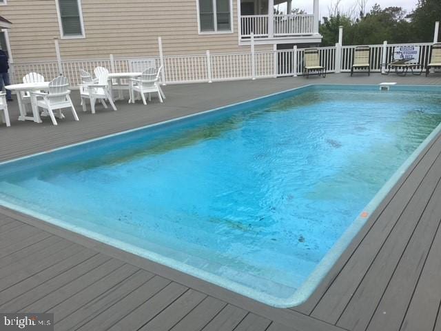 view of swimming pool featuring a deck