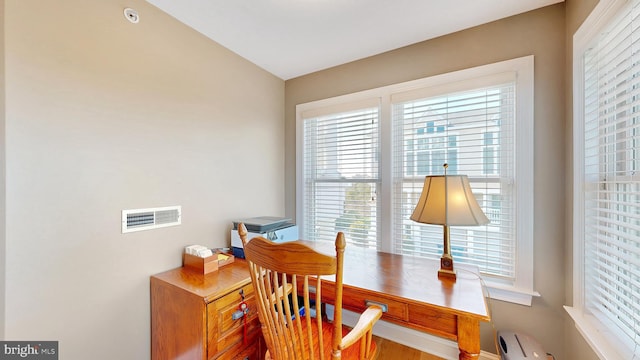 home office featuring hardwood / wood-style floors and vaulted ceiling