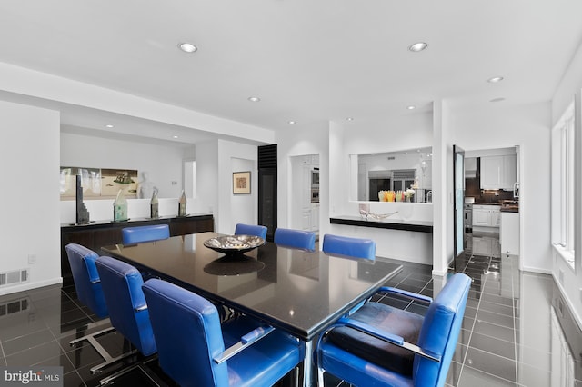 dining area with dark tile flooring