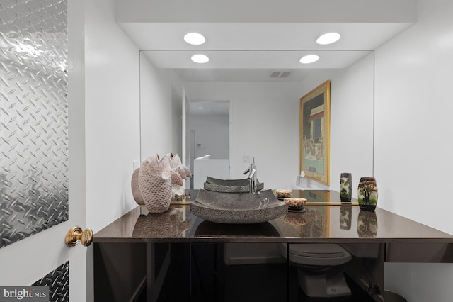 bathroom featuring toilet and large vanity