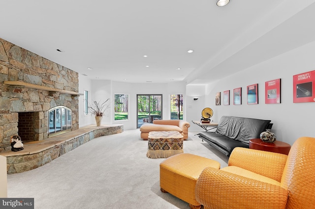 living room with carpet flooring and a fireplace