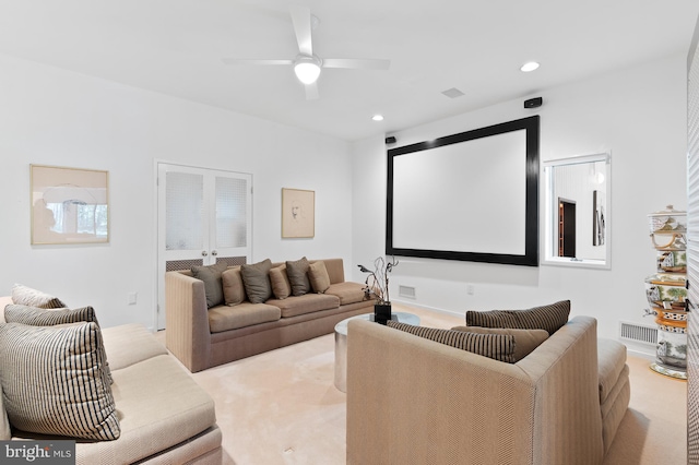 carpeted cinema room with ceiling fan