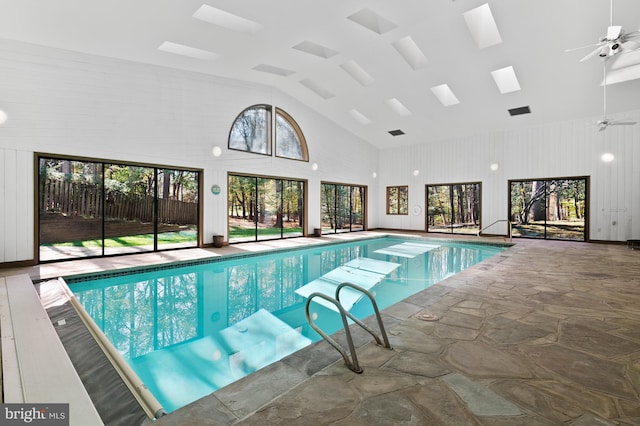 view of swimming pool featuring a skylight and ceiling fan