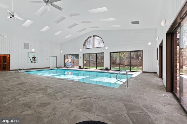 view of pool with a skylight and ceiling fan