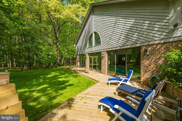 wooden terrace with a lawn