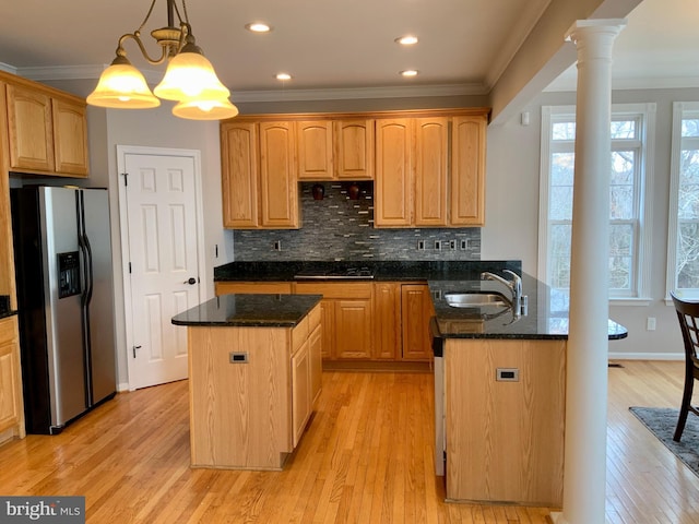 kitchen featuring sink, dark stone countertops, hanging light fixtures, a notable chandelier, and appliances with stainless steel finishes