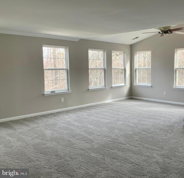 carpeted spare room with lofted ceiling and ceiling fan