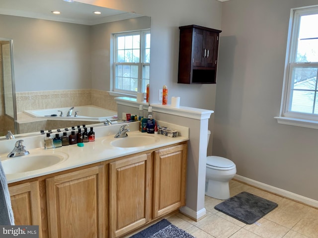 bathroom featuring a healthy amount of sunlight, vanity, tile patterned floors, and toilet