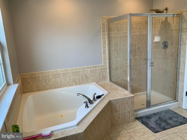 bathroom with tile patterned flooring and independent shower and bath