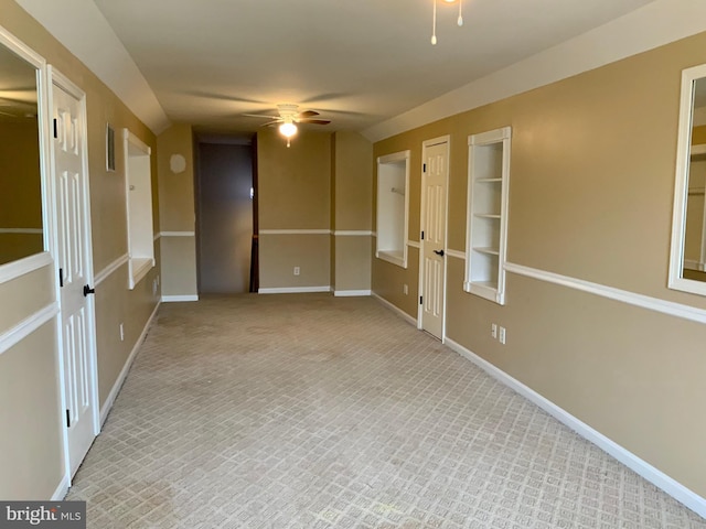 carpeted spare room with lofted ceiling and ceiling fan