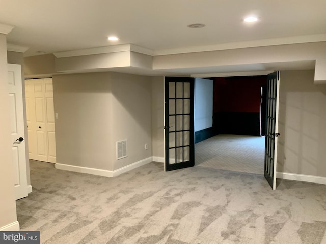 basement featuring carpet floors and ornamental molding