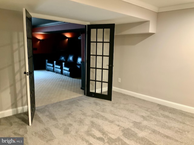 empty room with ornamental molding, french doors, and light carpet