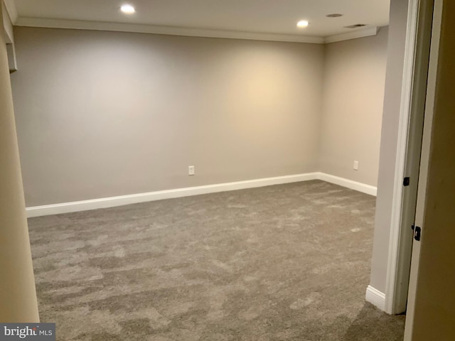 unfurnished room featuring carpet and crown molding