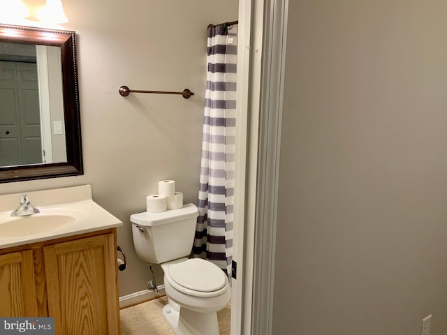 bathroom featuring toilet and vanity