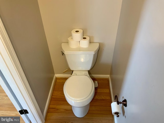 bathroom with toilet and hardwood / wood-style floors