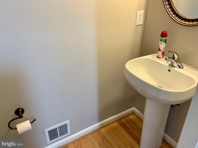 bathroom with sink and hardwood / wood-style floors