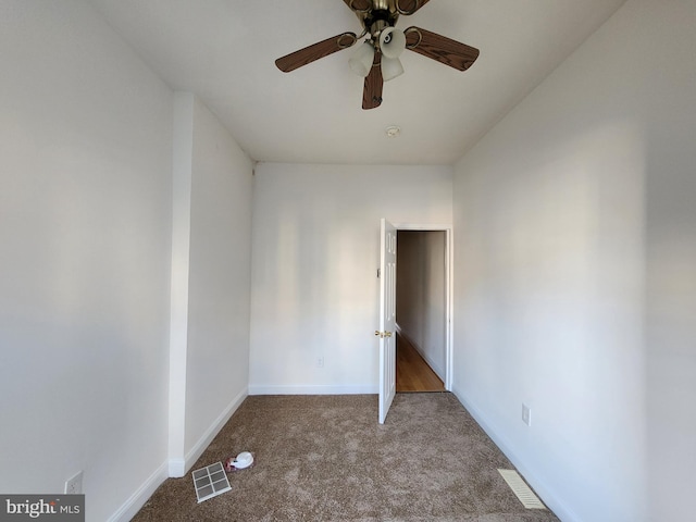 empty room with ceiling fan and carpet floors