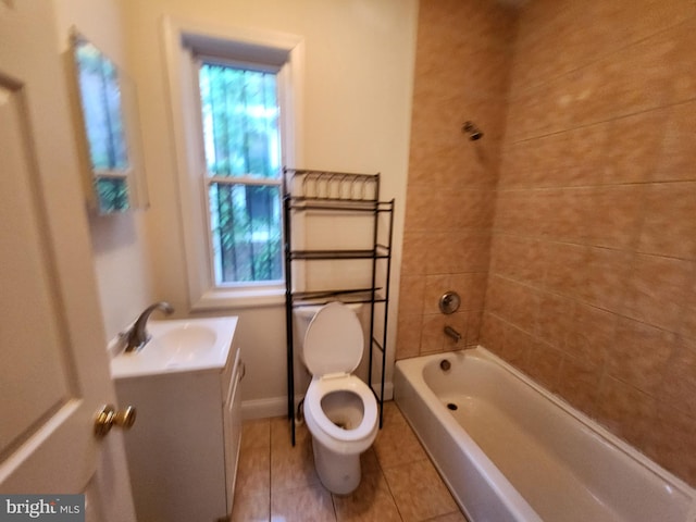 bathroom featuring a healthy amount of sunlight, toilet, tile flooring, and vanity