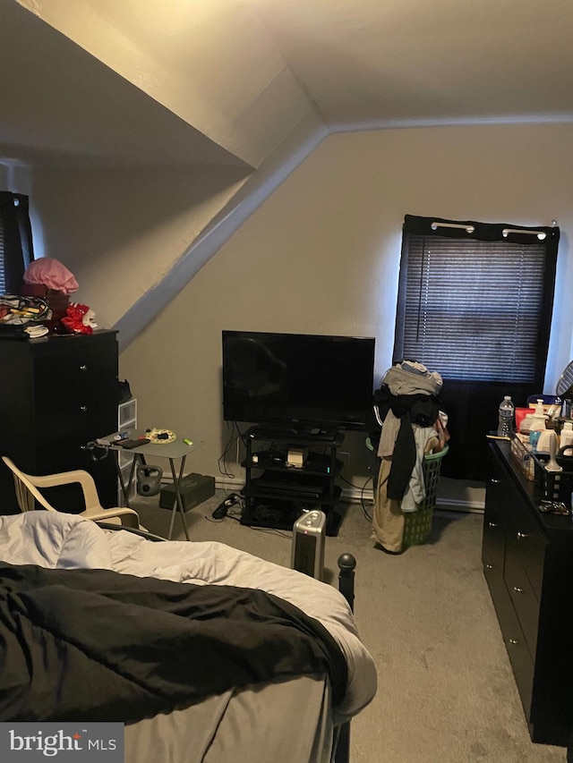 carpeted bedroom featuring lofted ceiling