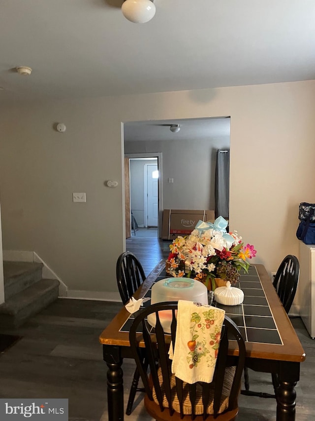 dining area with dark wood-type flooring