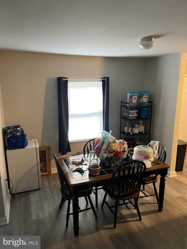 dining room with hardwood / wood-style flooring